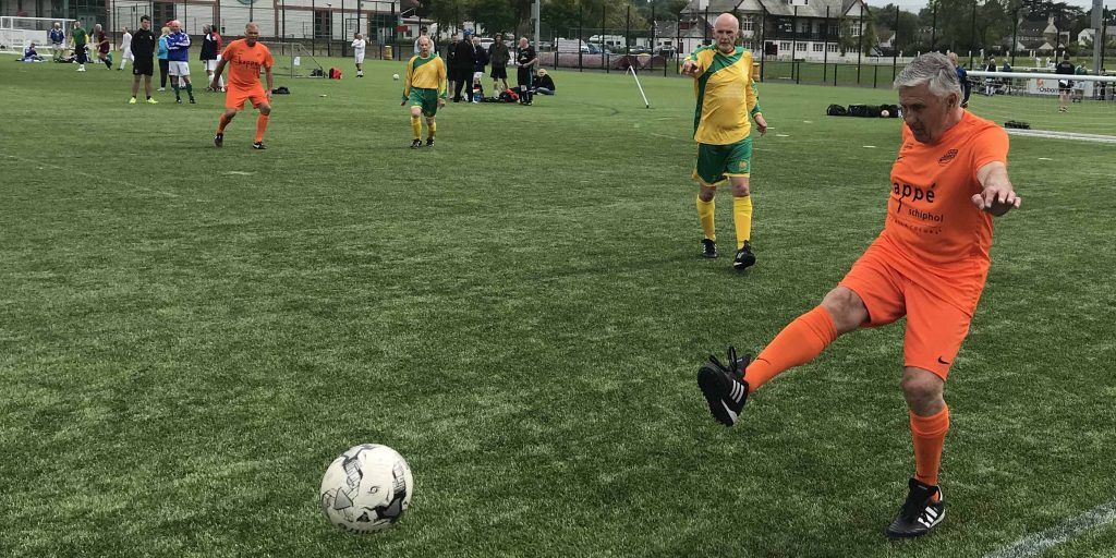 Eldery men playing football